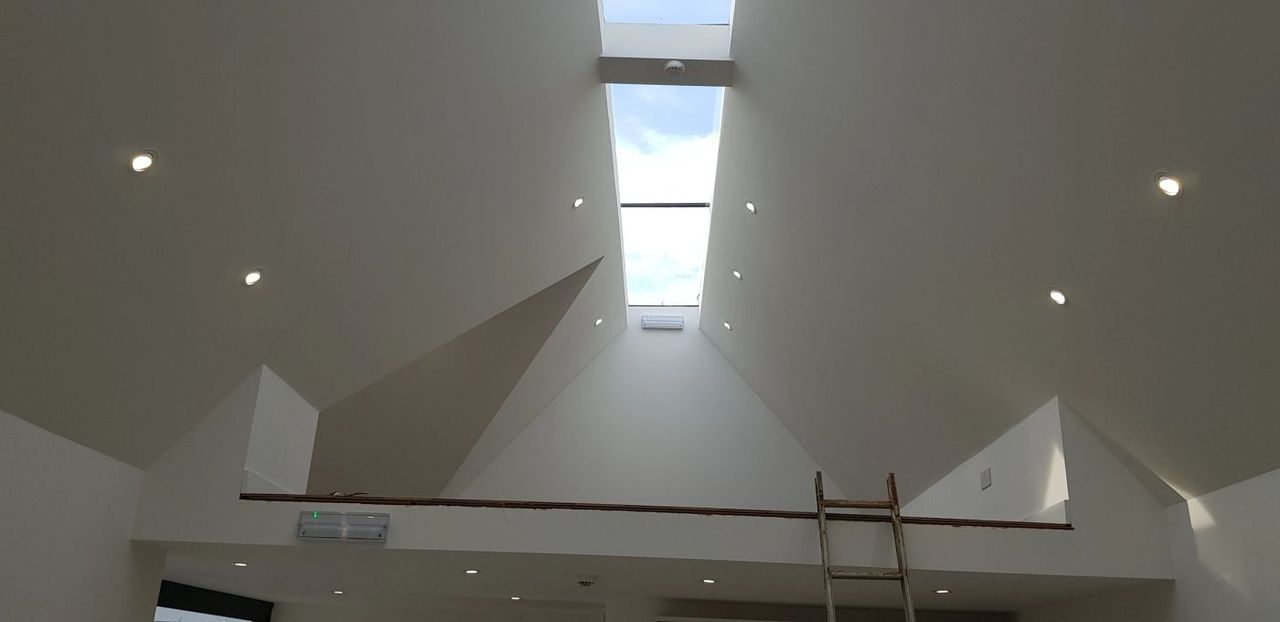 Recessed LED downlights and emergency light fitting in a vaulted ceiling