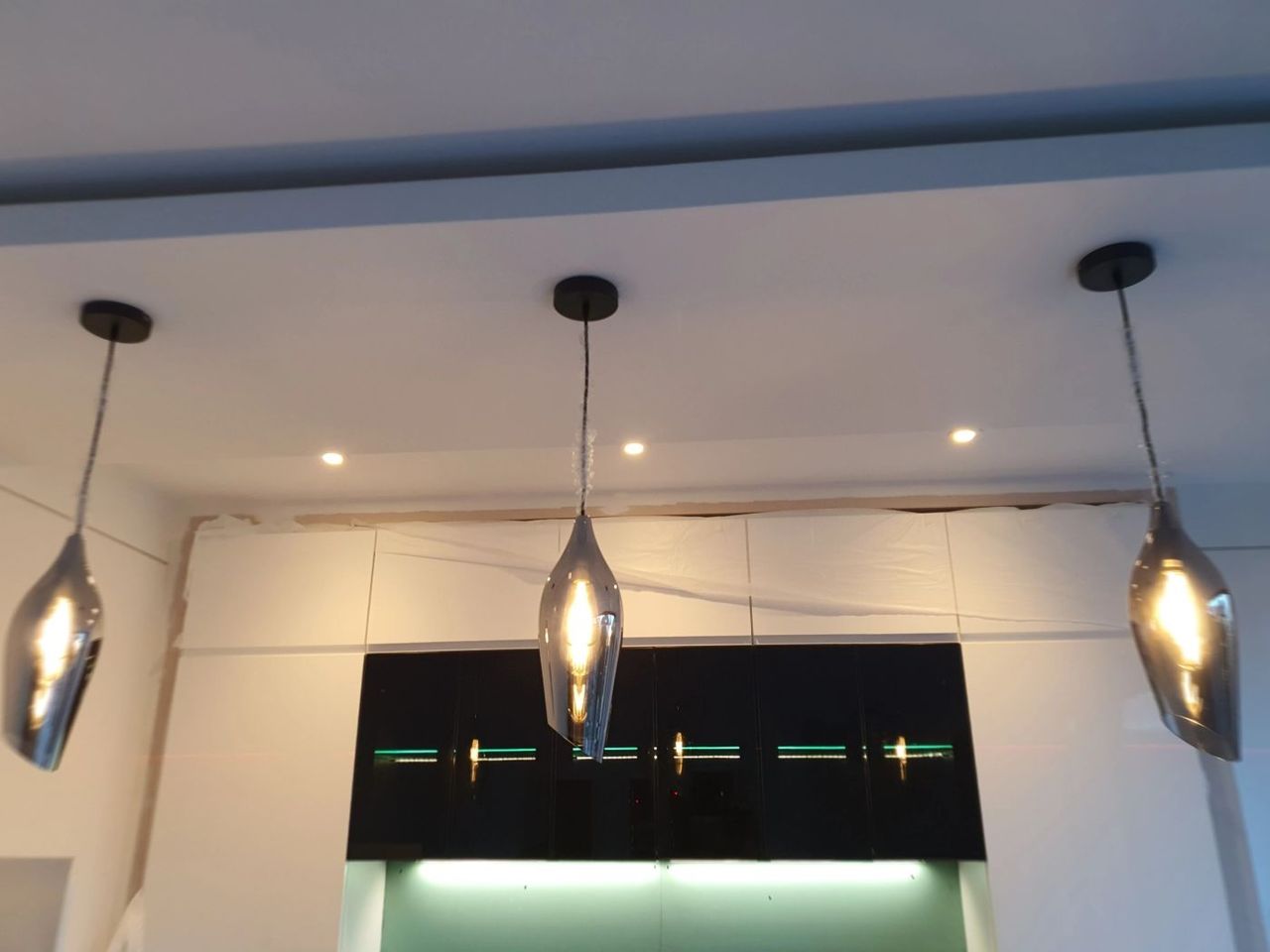 Pendant lighting and LED strip lighting over a kitchen island